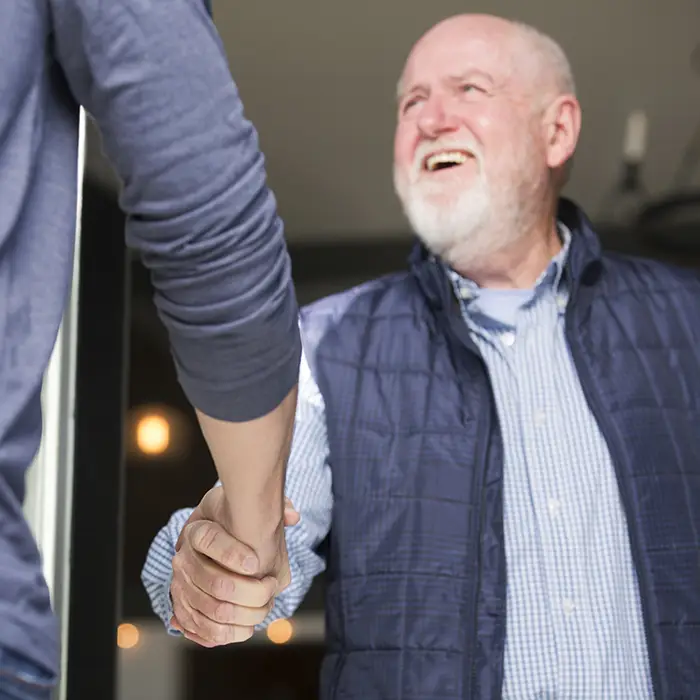 Church volunteer greeting attendees at an event